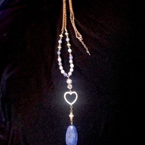 Long silver toned necklace with a beautiful blue stone